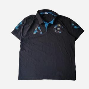 Lacoste Sport black polo shirt with blue camouflage accents on shoulders and che